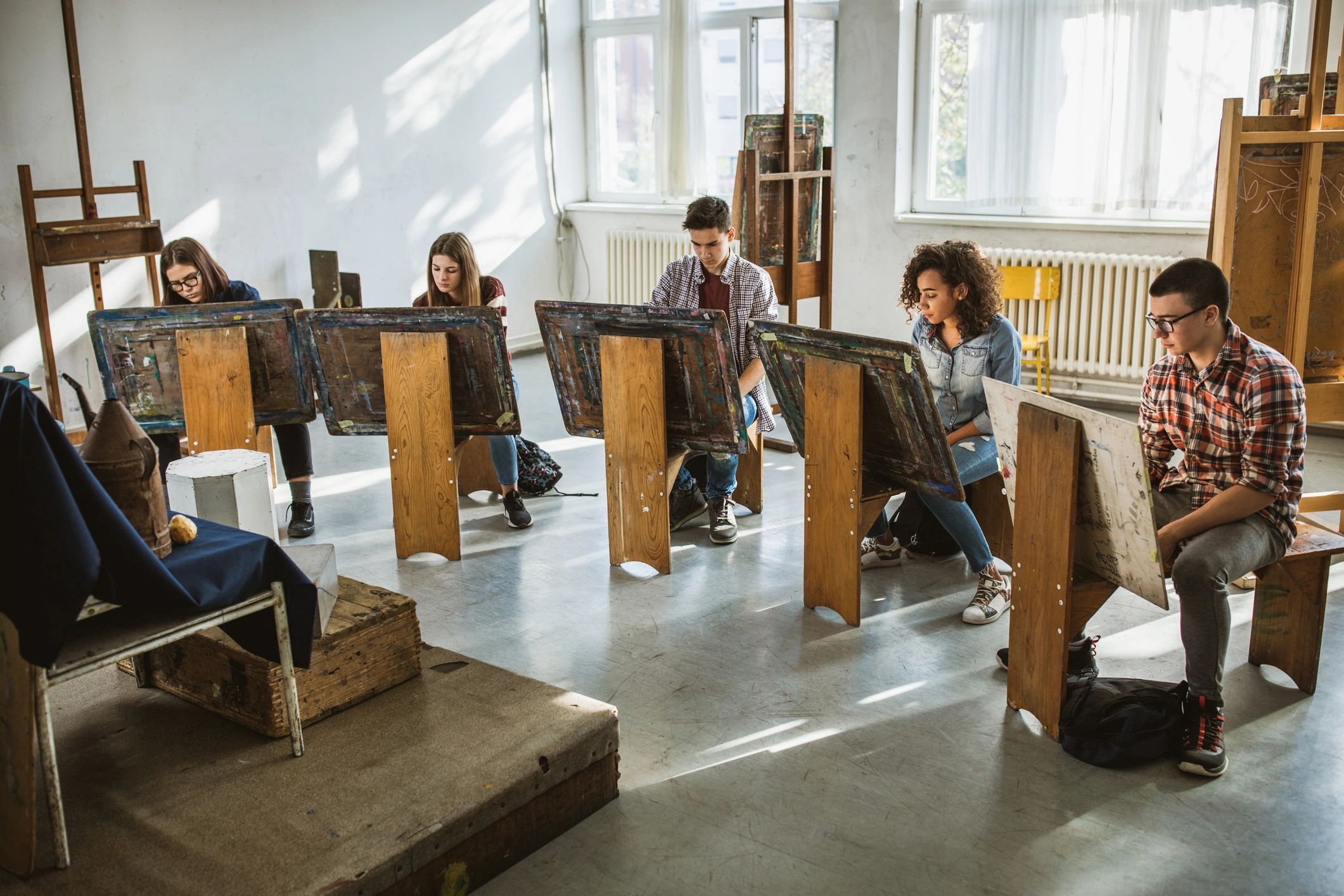 Students creating artwork together in an art studio