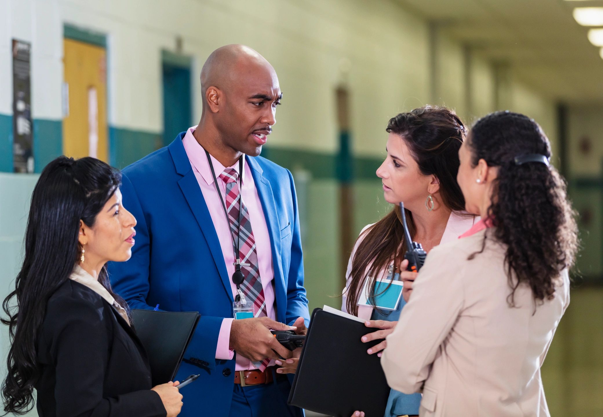 School leaders meeting together in a hallway