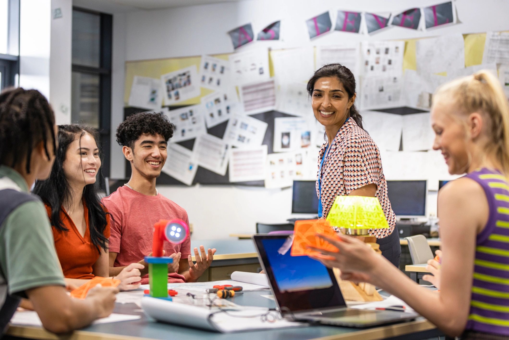 Students collaborating with a teacher on classroom work