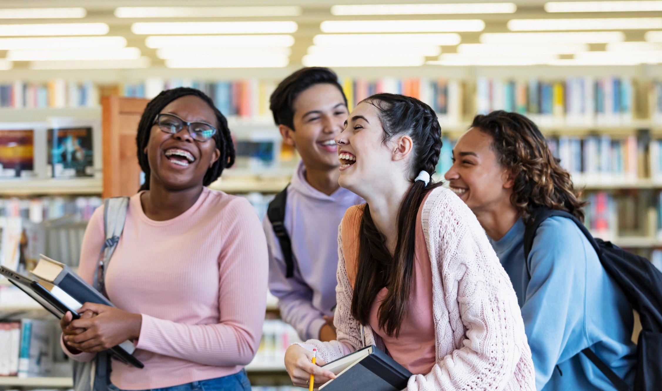 High school students walking together in a library