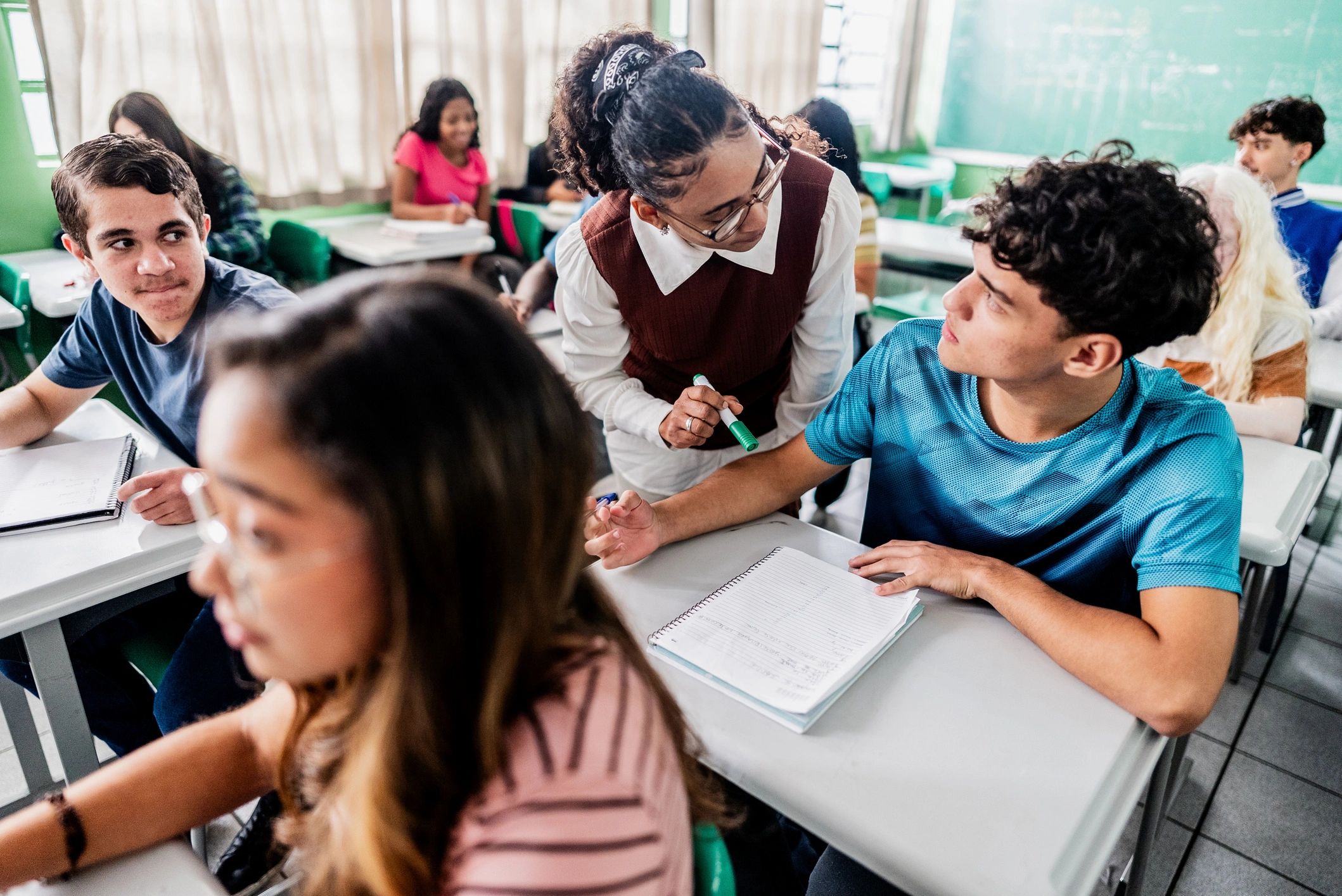 Teacher supporting a student during class